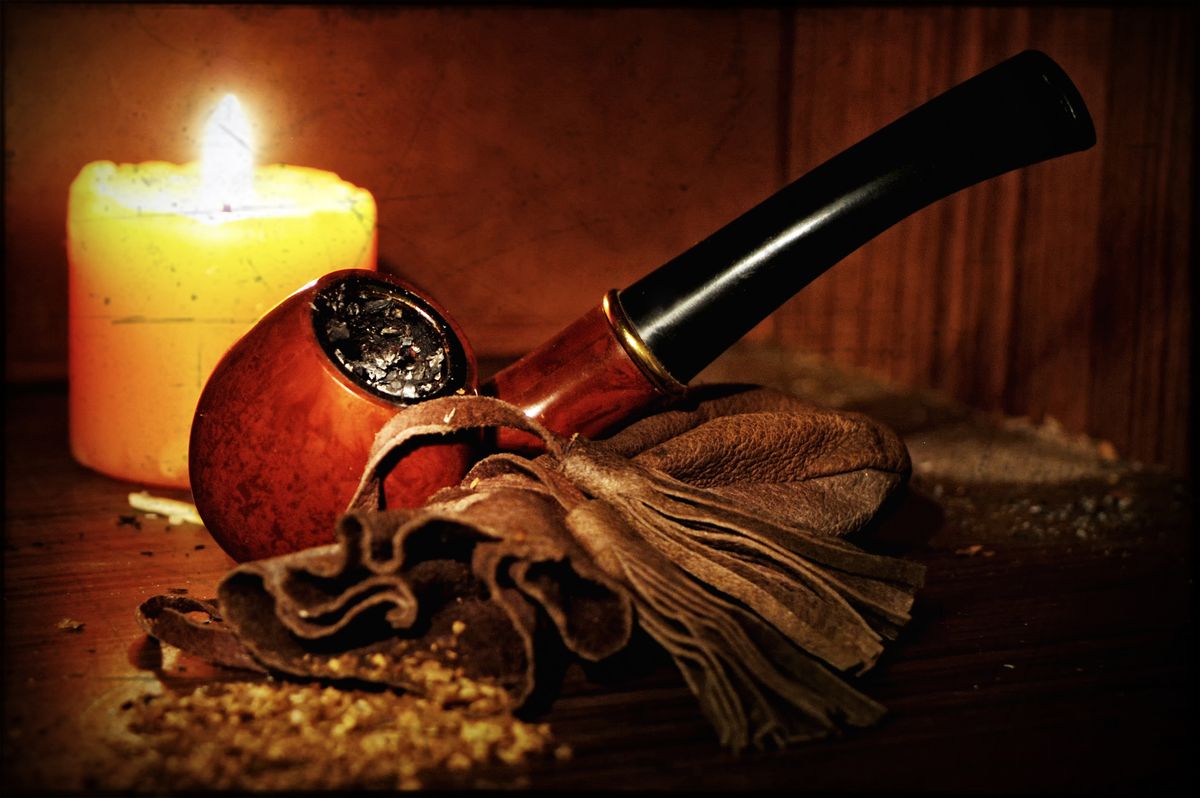 Pipe,With,Leather,Bag,Full,Of,Tobacco,And,Candle,On
