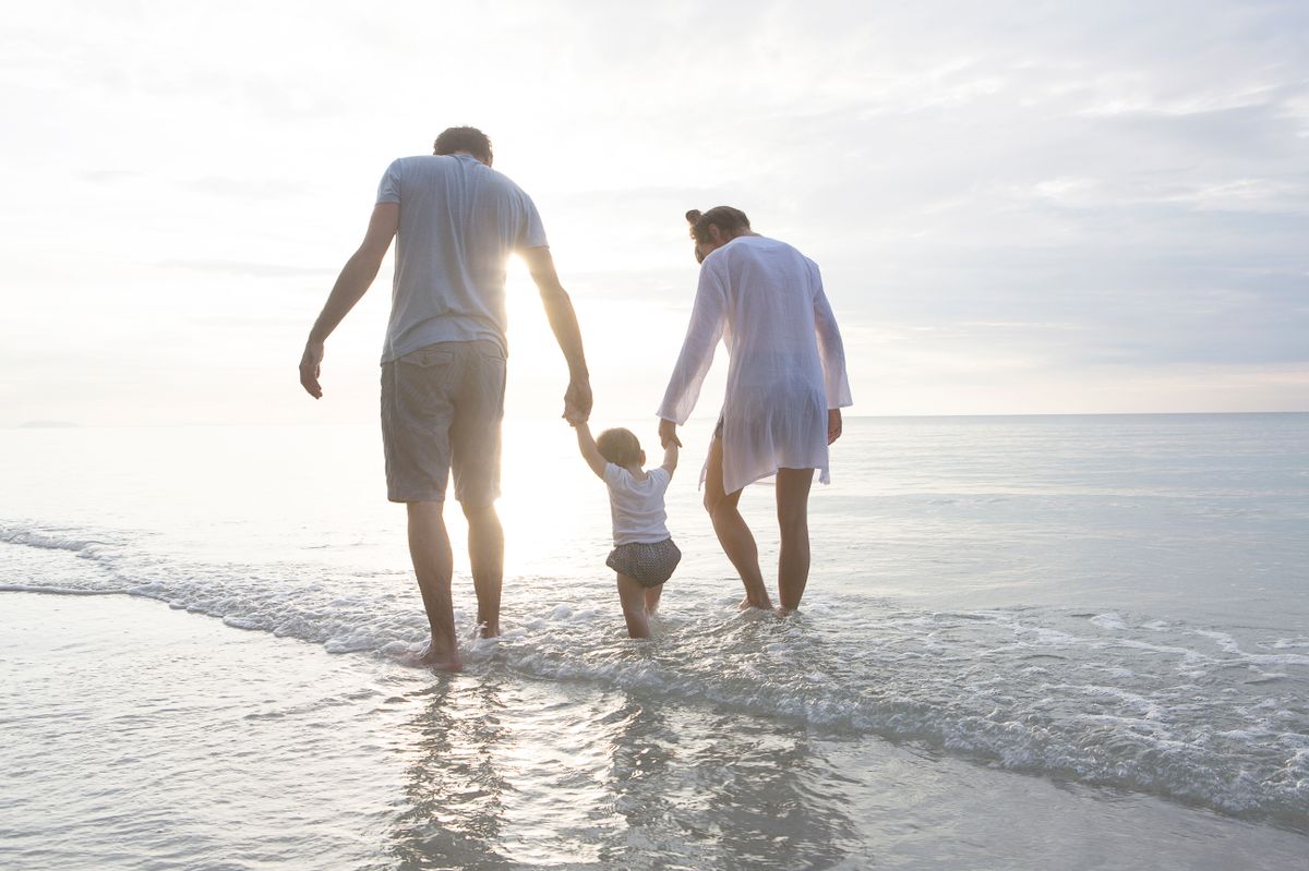 family walking in the sea in thailand