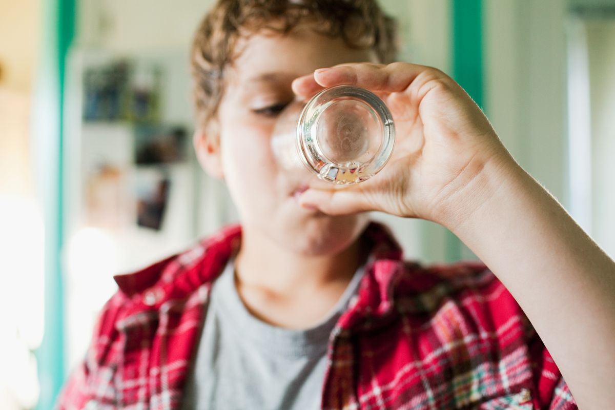 Boy finishing glass of juice