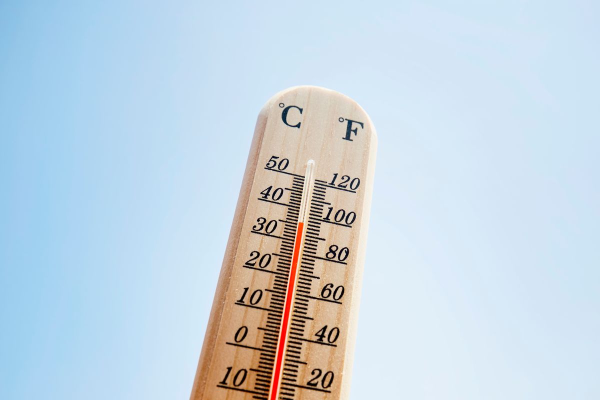 Thermometer against blue sky