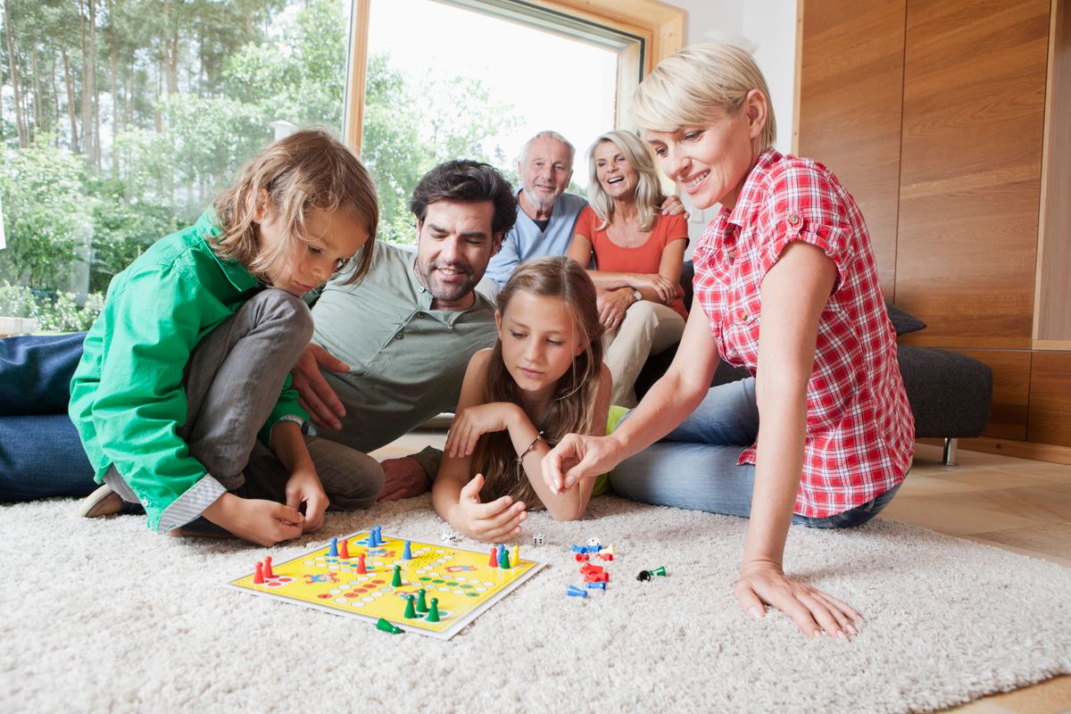 Germany, Bavaria, Nuremberg, Family playing board game together
