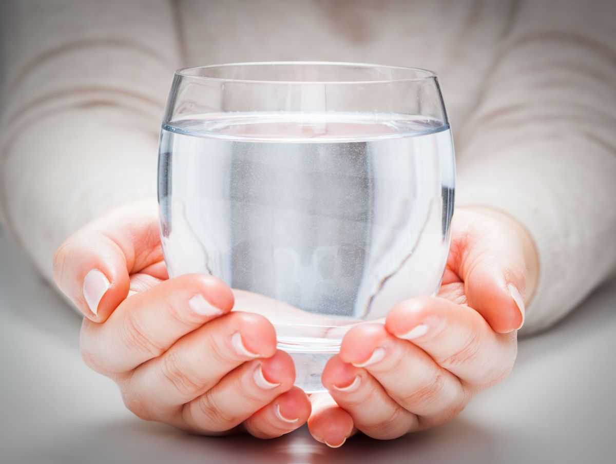 A,Glass,Of,Clean,Mineral,Water,In,Woman's,Hands.,Concept