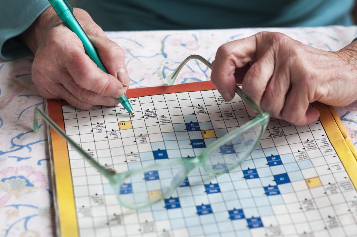 Senior,Women,Sitting,At,A,Table,And,Solve,Crosswords.