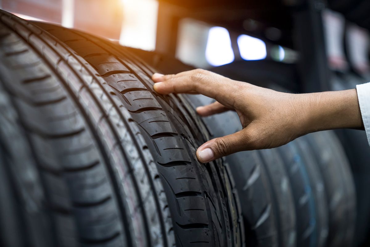 Hand finger checking tire