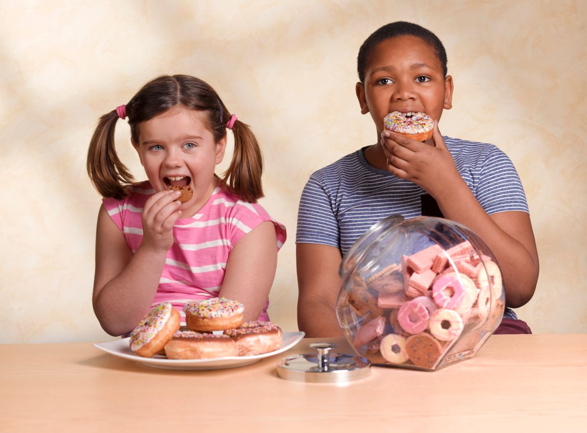 Kids eating cookie and doughnut