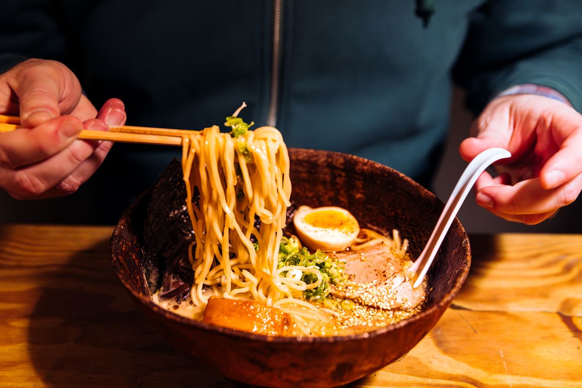 Man eating pork belly ramen at the ramen shop, close-up