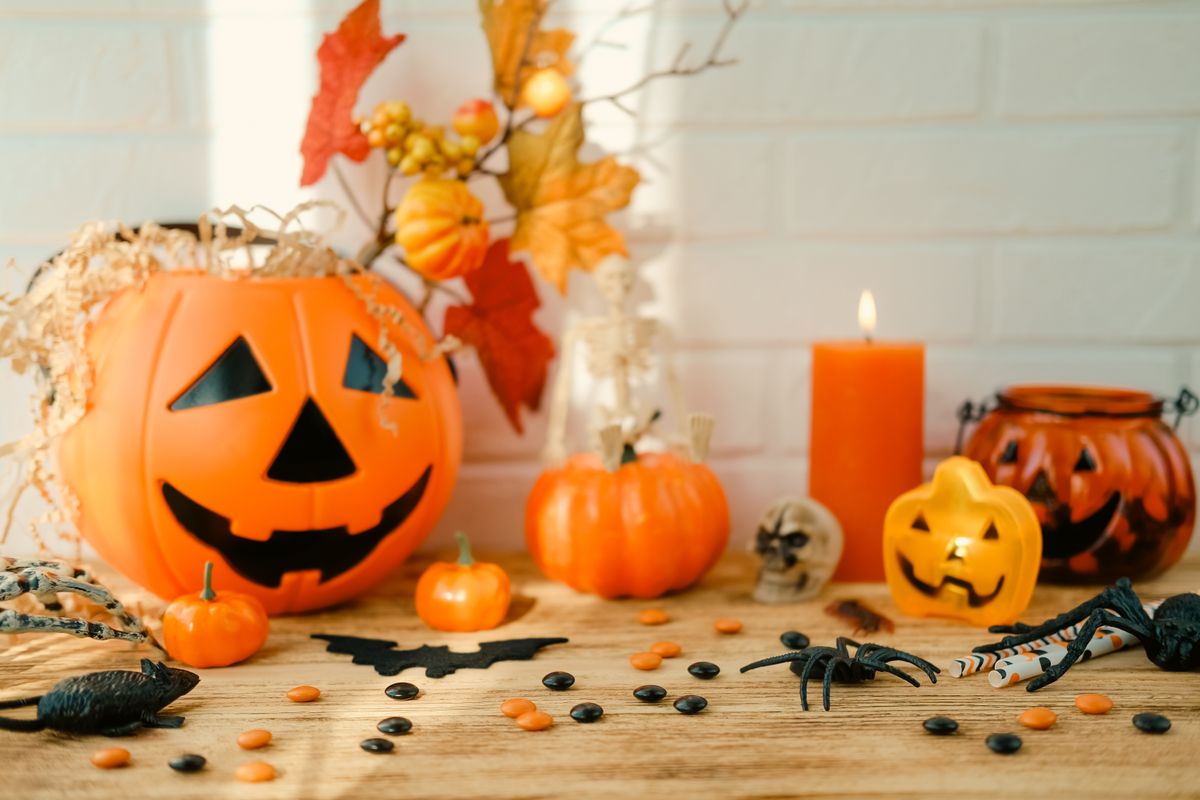 Jack-o-lantern with bouquet, a burning candle and Halloween set.